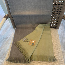 Load image into Gallery viewer, Featuring a soothing color palette of soft green and a light ash color, the Olive Branch reversible alpaca wrap has earthy comforts written all over it.Being wrapped in this beautiful accessory is like snuggling inside the comfiest cocoon, courtesy of a signature blend of alpaca fiber. Soft, lightweight, warm, and durable, this is an ultra-functional piece that would instantly give your wardrobe an upgrade. Material: 35% Baby Alpaca 35% Super Fine Alpaca 30% Acrylic Size: 27"x 76" Made in Peru