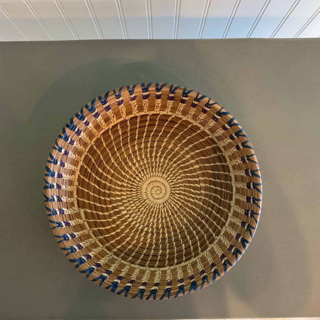 This handy straight-sided pine needle basket has colorful raffia accents and is part of a series of similar baskets. Pine needles with raffia. Approximately 9