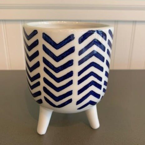 Blue Lagoon Candle in a ceramic footed container, navy chevron pattern on white background.  Lovely fragrance.