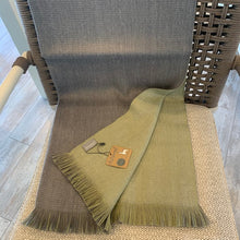 Load image into Gallery viewer, Featuring a soothing color palette of soft green and a light ash color, the Olive Branch reversible alpaca wrap has earthy comforts written all over it.Being wrapped in this beautiful accessory is like snuggling inside the comfiest cocoon, courtesy of a signature blend of alpaca fiber.  Soft, lightweight, warm, and durable, this is an ultra-functional piece that would instantly give your wardrobe an upgrade.  Material: 35% Baby Alpaca 35% Super Fine Alpaca 30% Acrylic  Size: 27&quot;x 76&quot; Made in Peru
