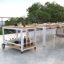 Load image into Gallery viewer, A wonderful addition to an outdoThe Makena Collection trolley is built from natural teak with a powder-coated aluminum frame.  It has a removable top tray and a 4-bottle wine rack on the lower shelf. 
