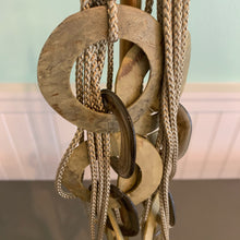 Load image into Gallery viewer, statement shell necklace is the perfect addition to a wearable art collection! The soft gold circular shell discs on this oh-so-unique statement necklace are linked together with resin links and complemented by multiple strands of tan rope, Maui Modern Home, Wailea, HI
